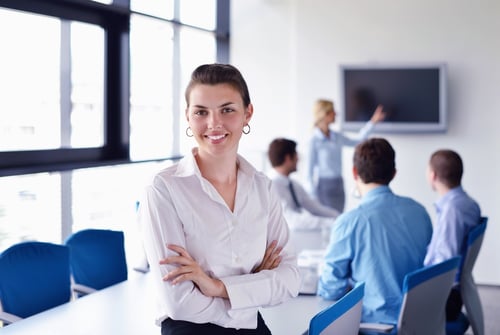 business woman with her staff, people group in background at modern bright office indoors